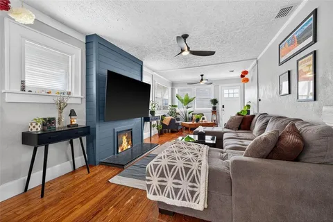 a living room with fireplace furniture and a flat screen tv