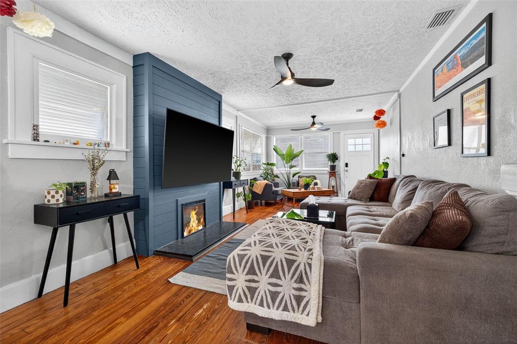 447 23rd Street North St. Petersburg, FL 33713 - Photo 7 of 28 a living room with fireplace furniture and a flat screen tv