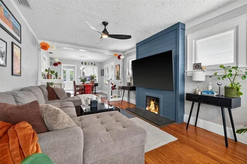 a living room with furniture a fireplace and a flat screen tv