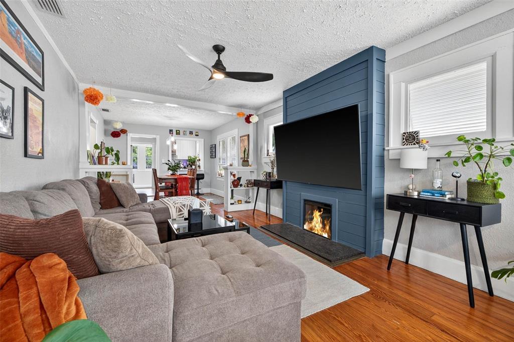 447 23rd Street North St. Petersburg, FL 33713 - Photo 8 of 28 a living room with furniture a fireplace and a flat screen tv