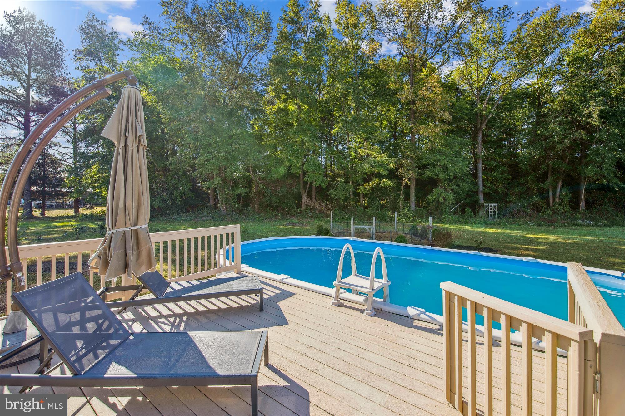 9044 Davis Road Pittsville, MD 21850 - Photo 24 of 43 a view of a chairs and table on the wooden deck