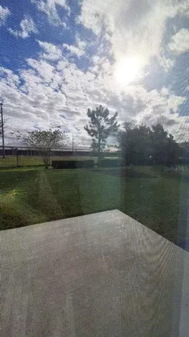 a view of kitchen with kitchen island sink refrigerator and cabinets