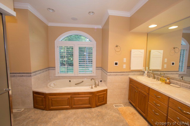 87 Eagle Point Road Lancaster, VA 22503 - Photo 16 of 36 a spacious bathroom with a tub sink and mirror