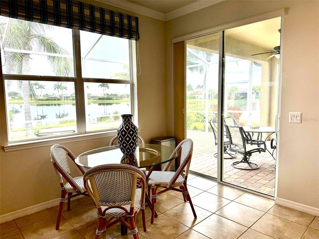 19240 Isadora Street Venice, FL 34293 - Photo 13 of 41 a dining room with furniture and large windows