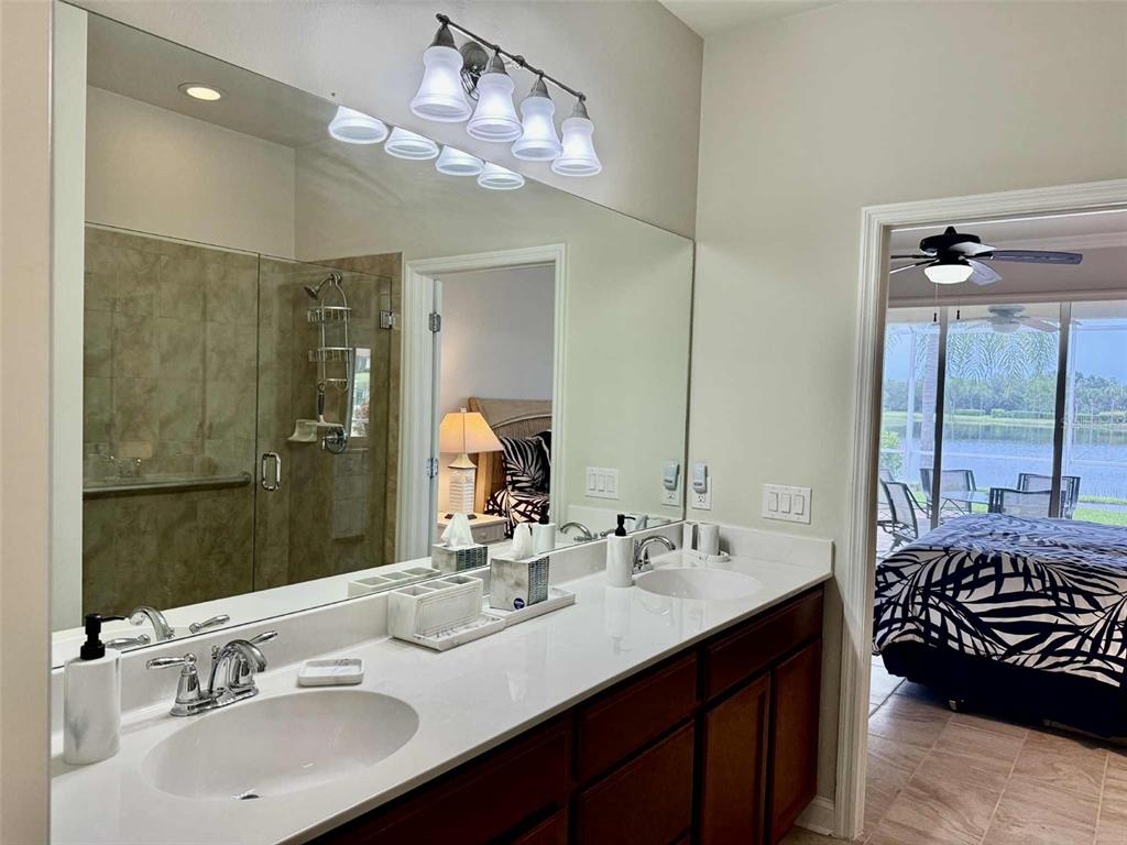 19240 Isadora Street Venice, FL 34293 - Photo 18 of 41 a bathroom with a double vanity sink mirror and next to a window