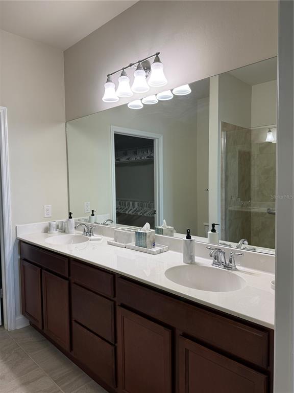 19240 Isadora Street Venice, FL 34293 - Photo 19 of 41 a bathroom with double vanity sinks and a mirror