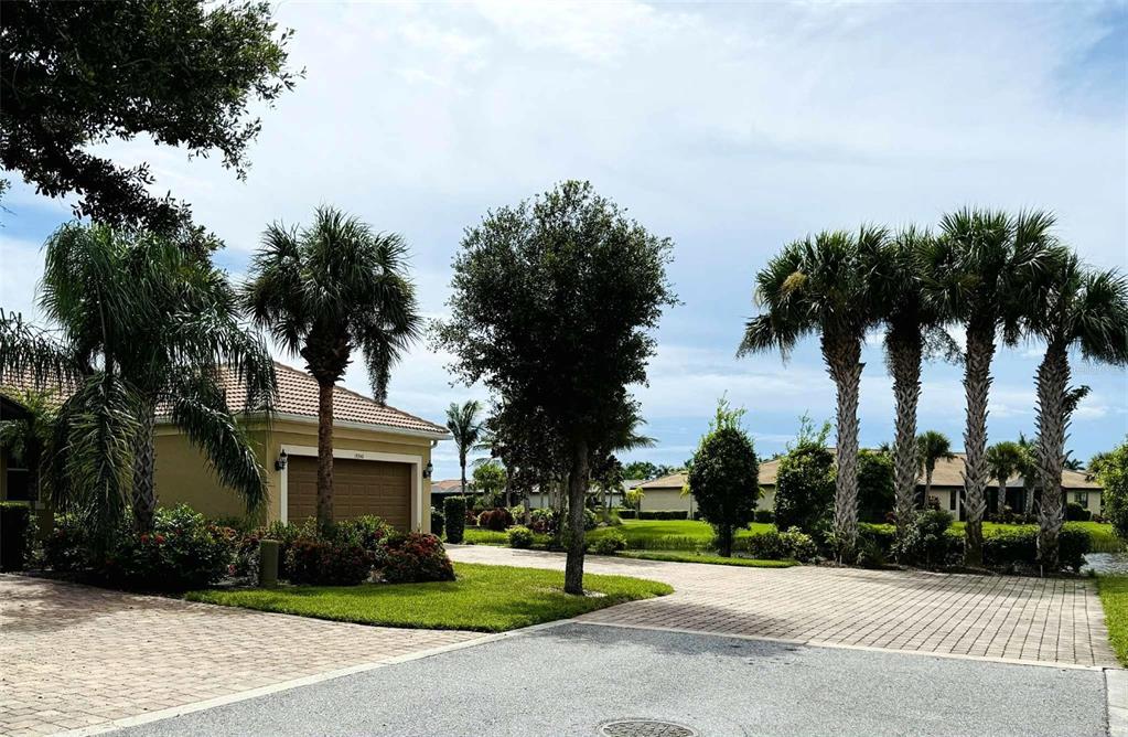 19240 Isadora Street Venice, FL 34293 - Photo 27 of 41 front view of a house with a garden