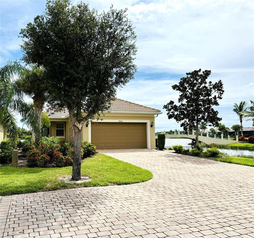 19240 Isadora Street Venice, FL 34293 - Photo 29 of 41 a front view of a house with a yard and garage