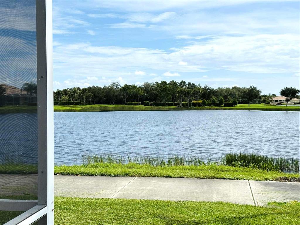 19240 Isadora Street Venice, FL 34293 - Photo 31 of 41 a view of a lake with houses in the background