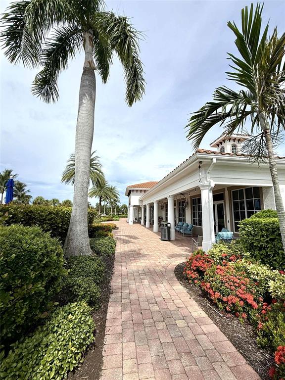 19240 Isadora Street Venice, FL 34293 - Photo 35 of 41 a front view of a house with a garden and trees