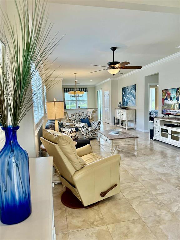 19240 Isadora Street Venice, FL 34293 - Photo 5 of 41 a living room with furniture and a chandelier