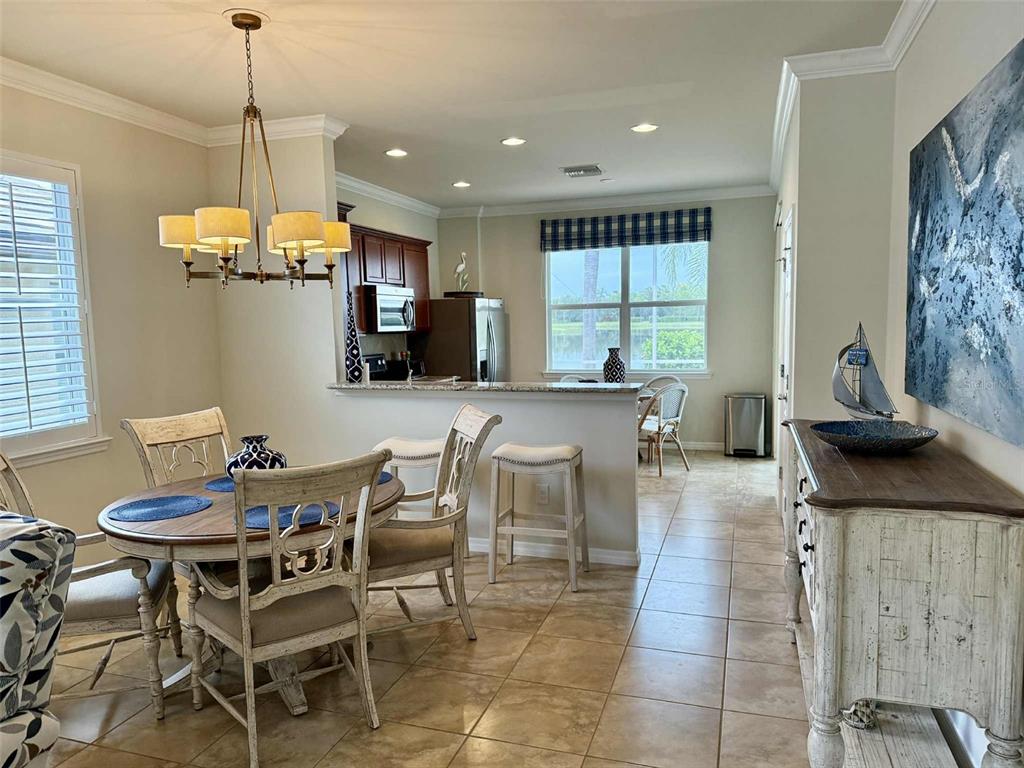 19240 Isadora Street Venice, FL 34293 - Photo 6 of 41 a dining room with furniture a chandelier and window