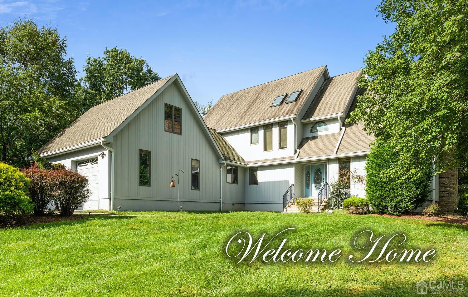 49 Brookside Road Millstone Township, NJ 08510 - Photo 1 of 60 a front view of a house with a garden