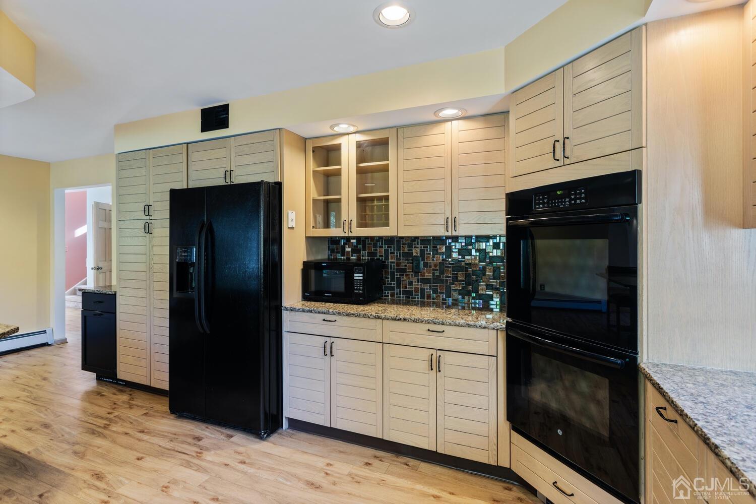 49 Brookside Road Millstone Township, NJ 08510 - Photo 12 of 60 a kitchen with stainless steel appliances kitchen island granite countertop a refrigerator and a stove top oven