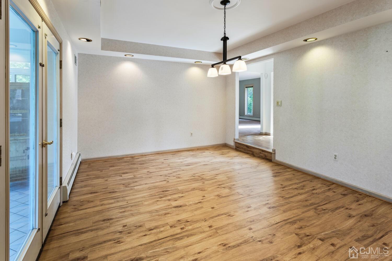 49 Brookside Road Millstone Township, NJ 08510 - Photo 17 of 60 a view of empty room with wooden floor and ceiling fan