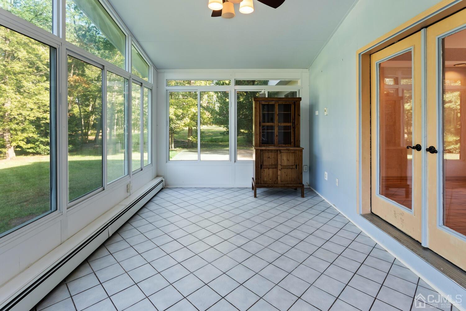 49 Brookside Road Millstone Township, NJ 08510 - Photo 19 of 60 an empty room with floor to ceiling windows and yard