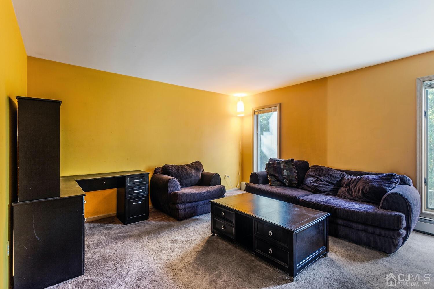 49 Brookside Road Millstone Township, NJ 08510 - Photo 20 of 60 a living room with furniture and a flat screen tv