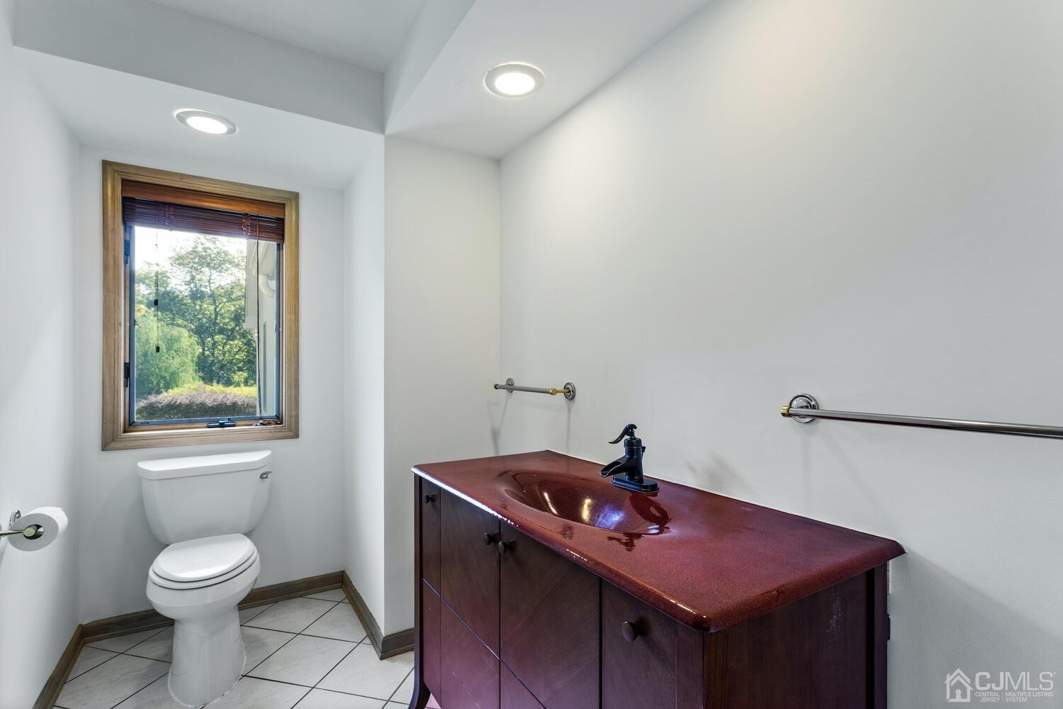 49 Brookside Road Millstone Township, NJ 08510 - Photo 22 of 60 a bathroom with a sink toilet and window