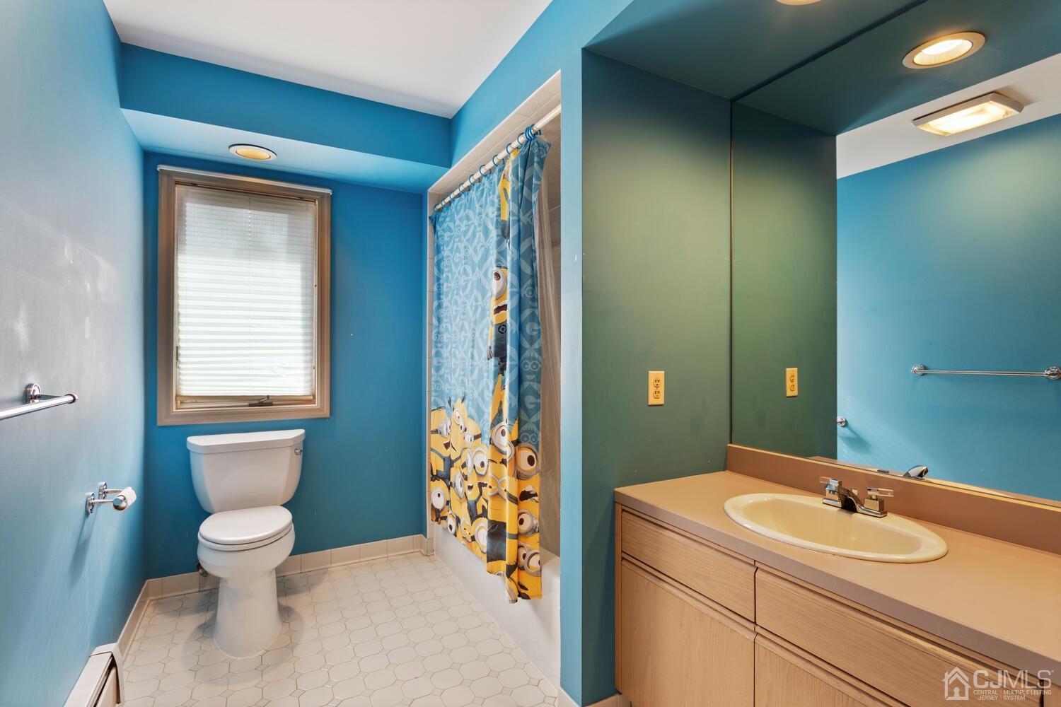 49 Brookside Road Millstone Township, NJ 08510 - Photo 38 of 60 a bathroom with a toilet sink and mirror