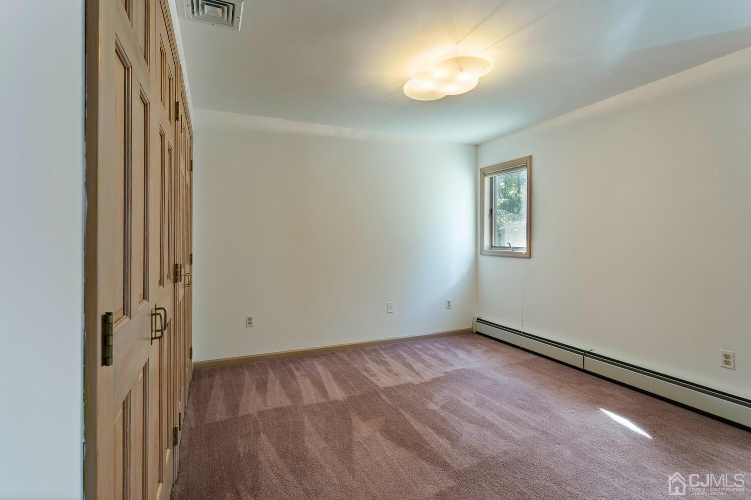 49 Brookside Road Millstone Township, NJ 08510 - Photo 39 of 60 an empty room with a view of a bathroom
