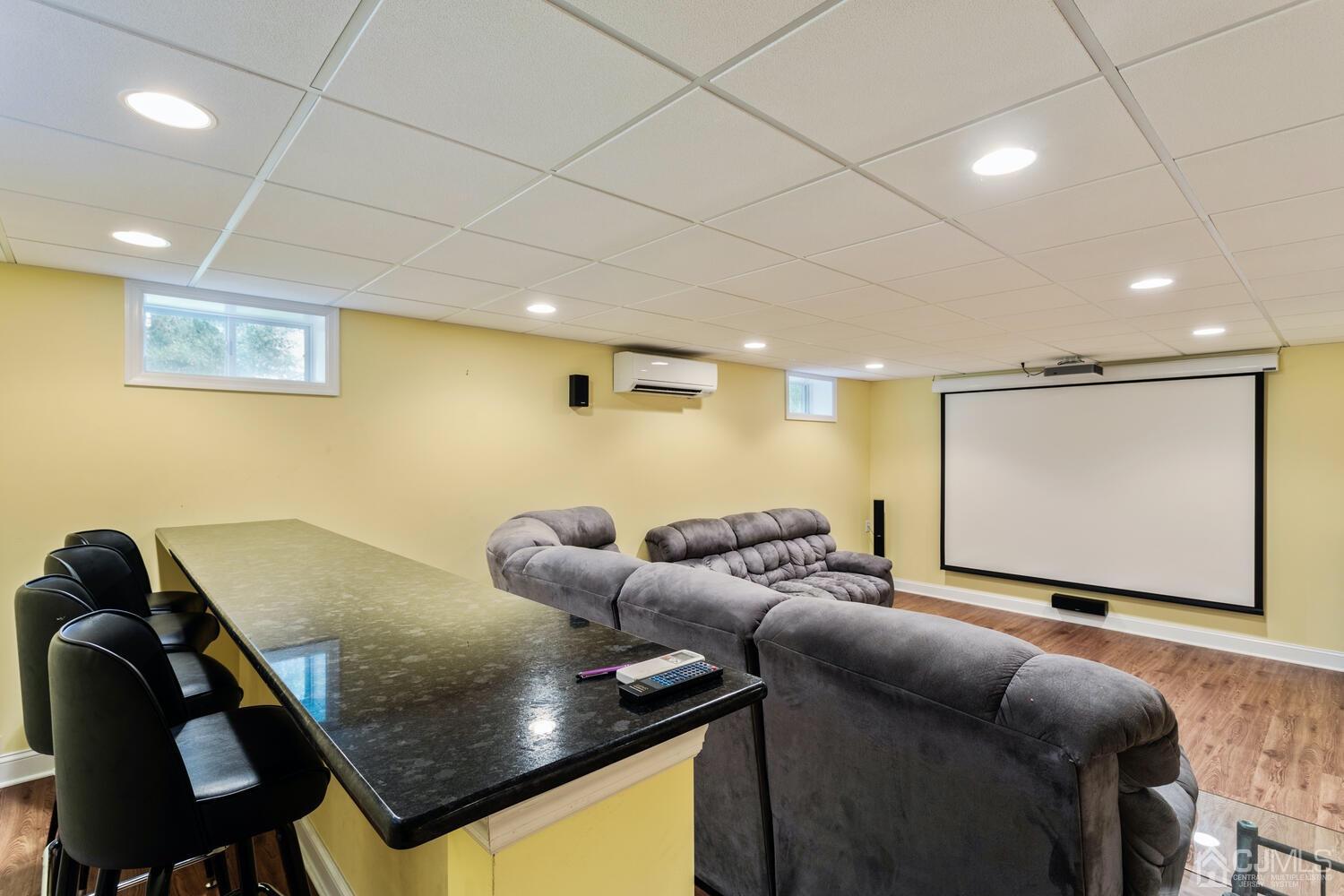 49 Brookside Road Millstone Township, NJ 08510 - Photo 43 of 60 a living room with furniture and a projector screen