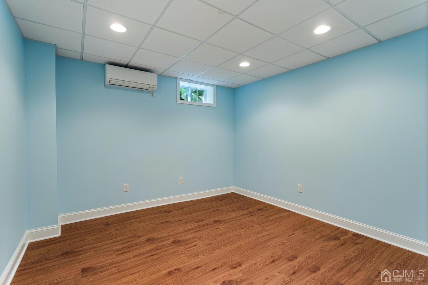 49 Brookside Road Millstone Township, NJ 08510 - Photo 45 of 60 an empty room with wooden floor and natural light