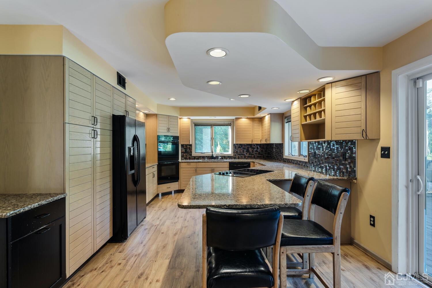 49 Brookside Road Millstone Township, NJ 08510 - Photo 8 of 60 a large kitchen with a table and chairs in it