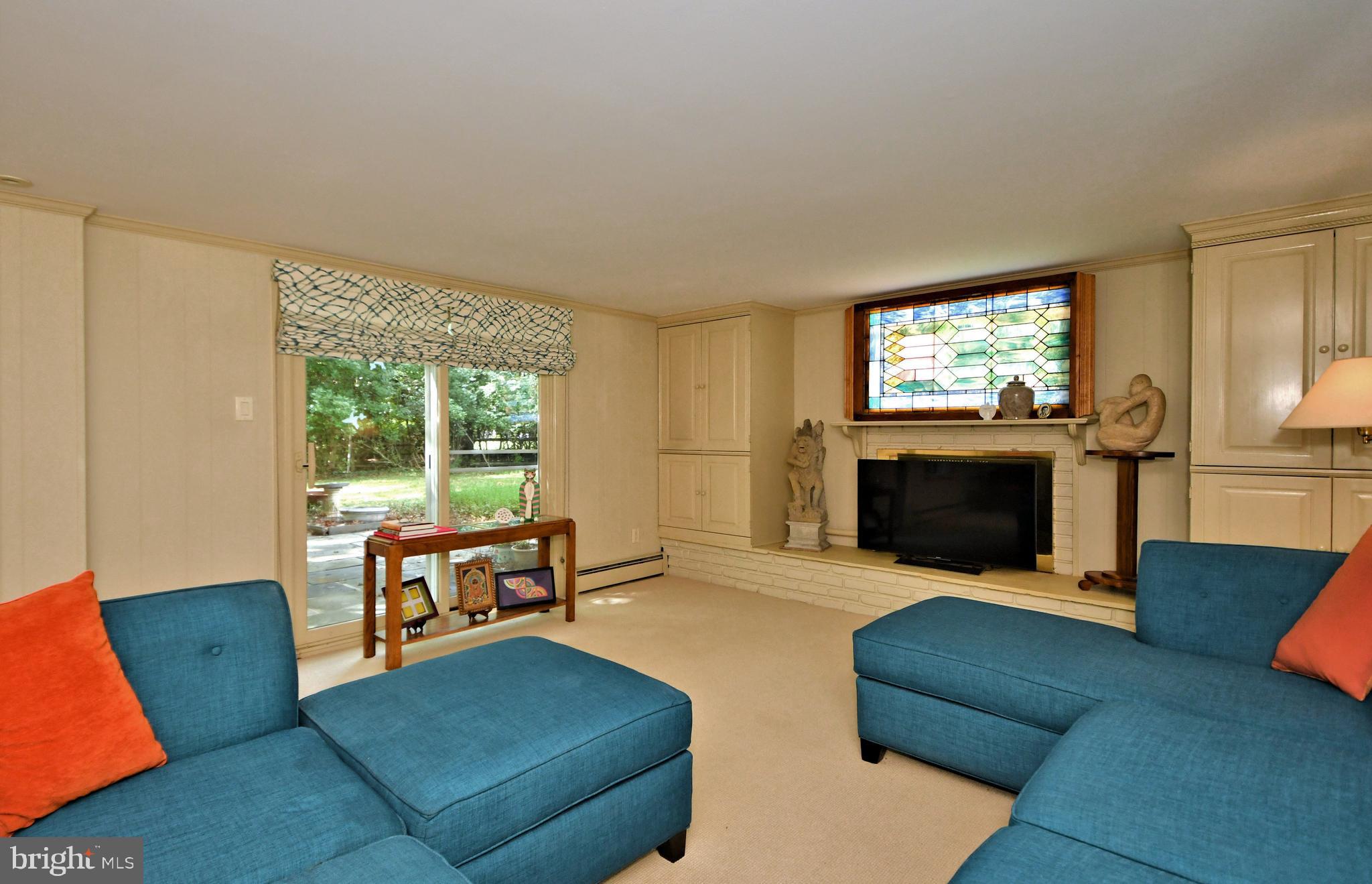 335 Powderhorn Road Fort Washington, PA 19034 - Photo 15 of 41 Great room w/fireplace and doors to stone patio