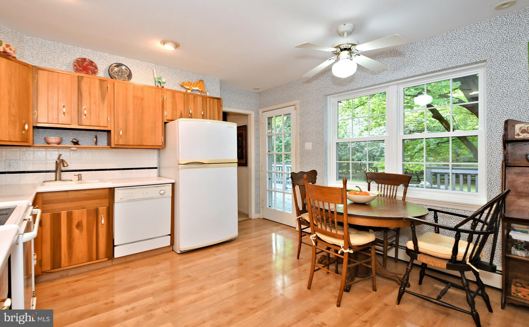 335 Powderhorn Road Fort Washington, PA 19034 - Photo 8 of 41 Eat-in kitchen w/door and windows overlooking deck