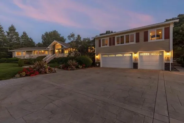 a front view of a house with a yard and garage