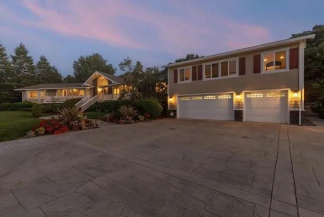 a front view of a house with a yard and garage