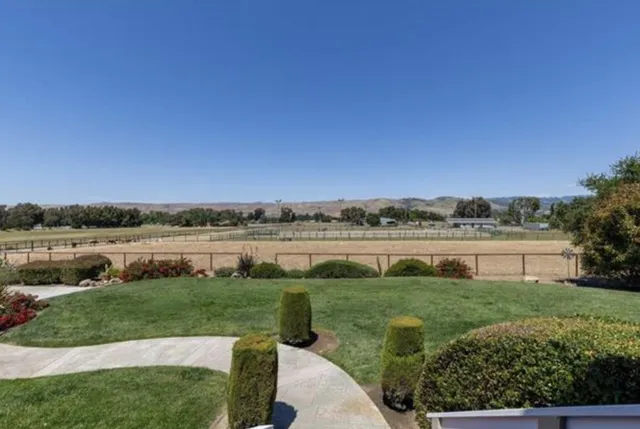 a view of a lake with a big yard and large trees