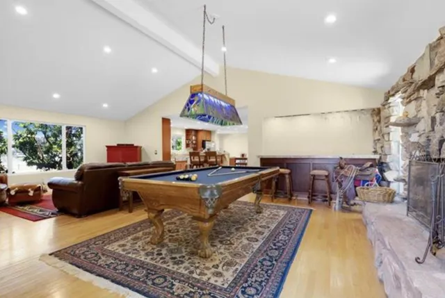 a living room with furniture a rug and a chandelier