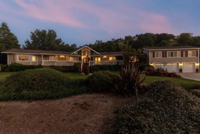 a front view of a house with a garden
