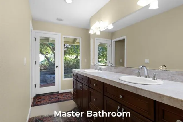 a bathroom with a sink a vanity and a large mirror