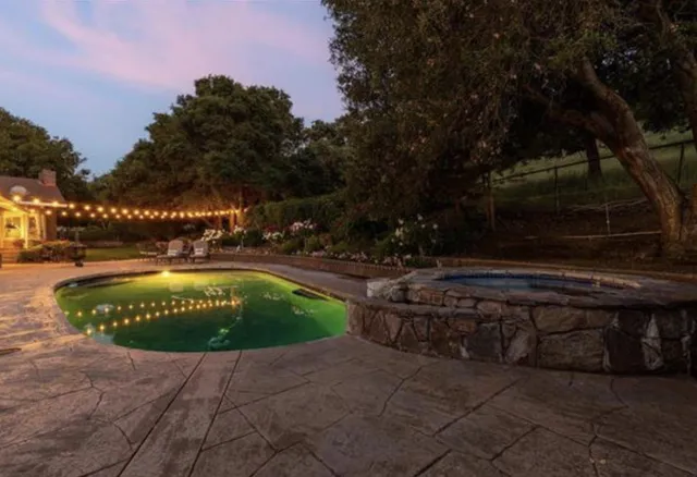 a view of an house with backyard space and balcony