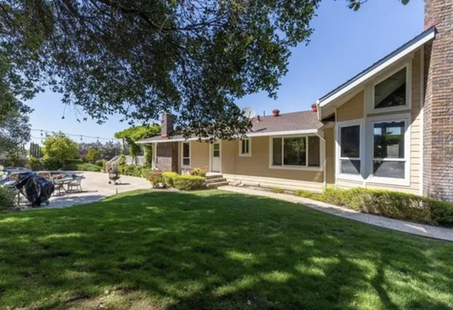 a kitchen with stainless steel appliances granite countertop a refrigerator a stove top oven a sink and dishwasher