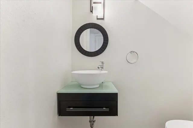 a bathroom with a sink a mirror and a toilet
