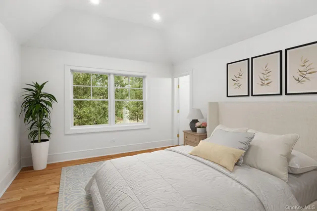 a bedroom with a large bed and a window