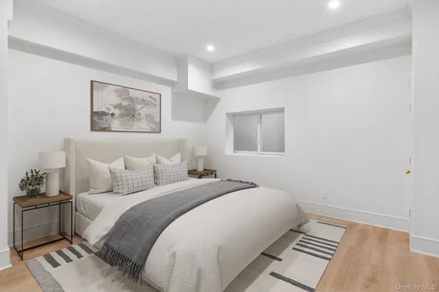 a bedroom with a bed and a painting on the wall