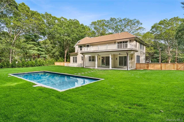 a view of a house with a yard table and chairs