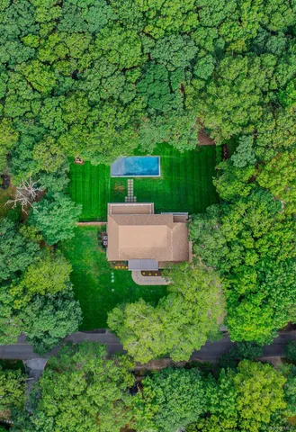 an aerial view of a house with pool tree s