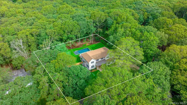 an aerial view of a house with a yard