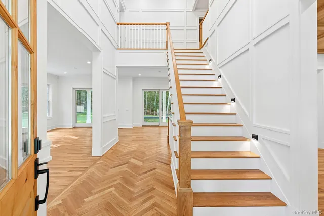 a view of entryway and hall with wooden floor