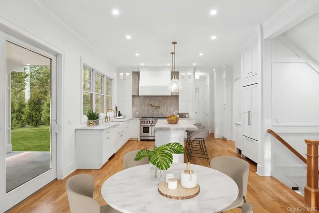 a dining room with furniture a window and wooden floor