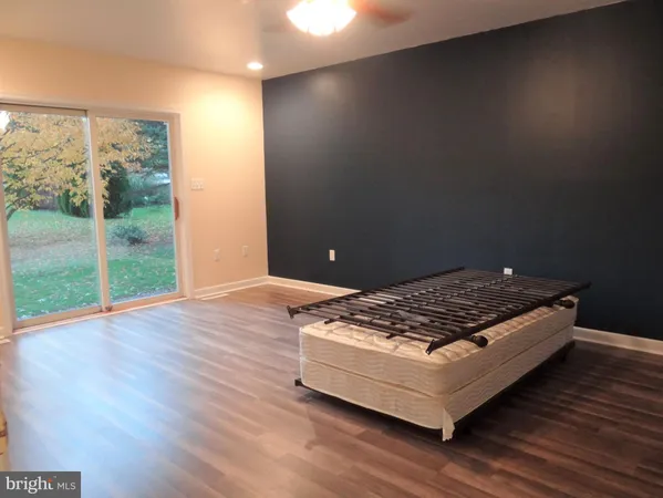 a view of a room with wooden floor and a window
