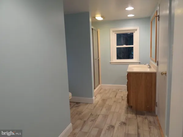 a view of hallway with wooden floor
