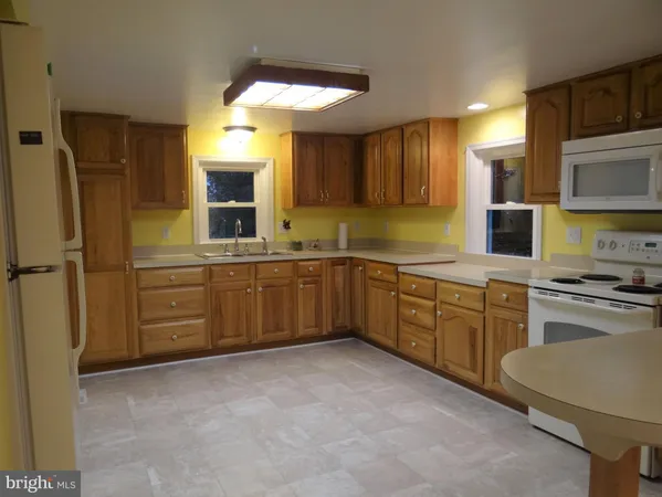 a kitchen with stainless steel appliances a sink stove refrigerator and cabinets