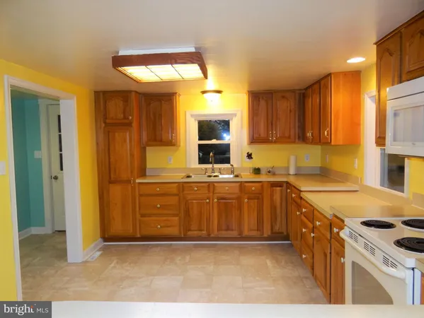 a kitchen with a sink a stove and cabinets