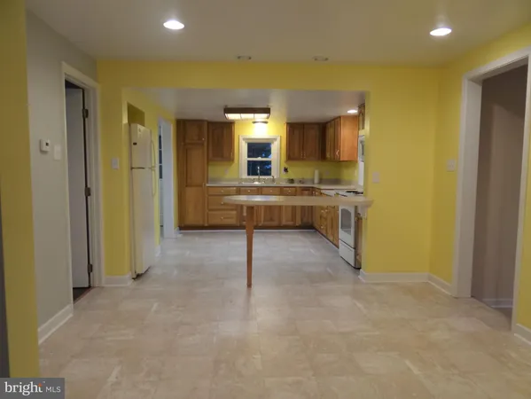a view of a living room with furniture and a kitchen
